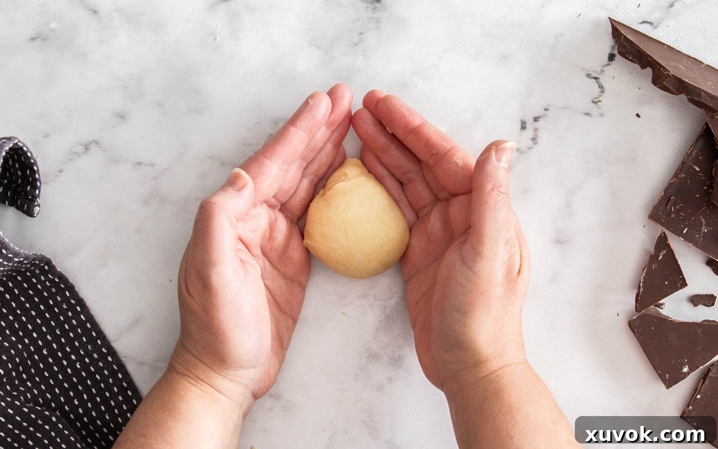 Rolling dough to form a ball.