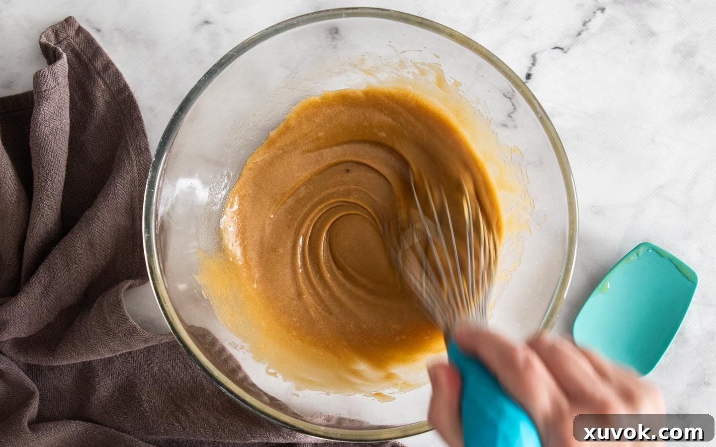Whisking the sugar and butter together.