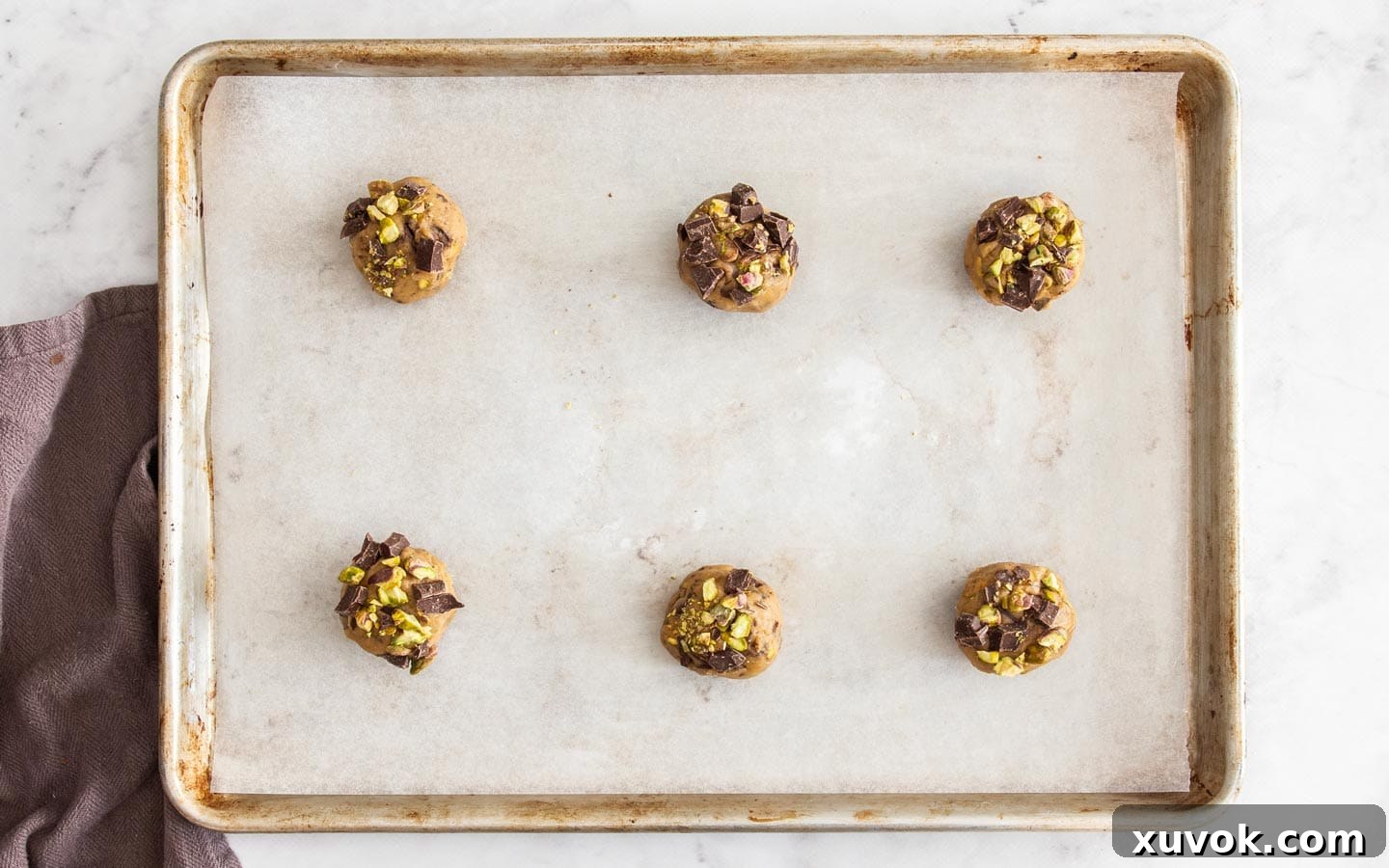 Balls of cookie dough on a baking tray.