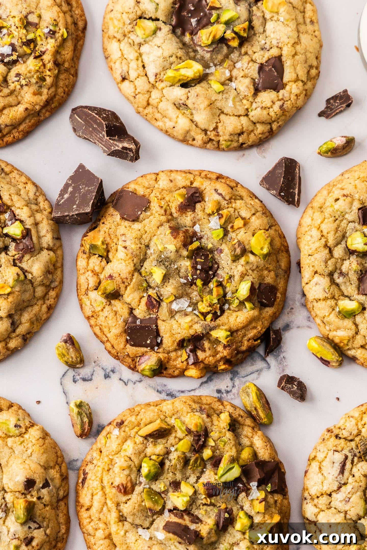 Closeup of the top of a chocolate chip pistachio cookie.