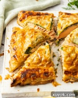 A salmon wellington cut into 6 pieces, showcasing the layers.