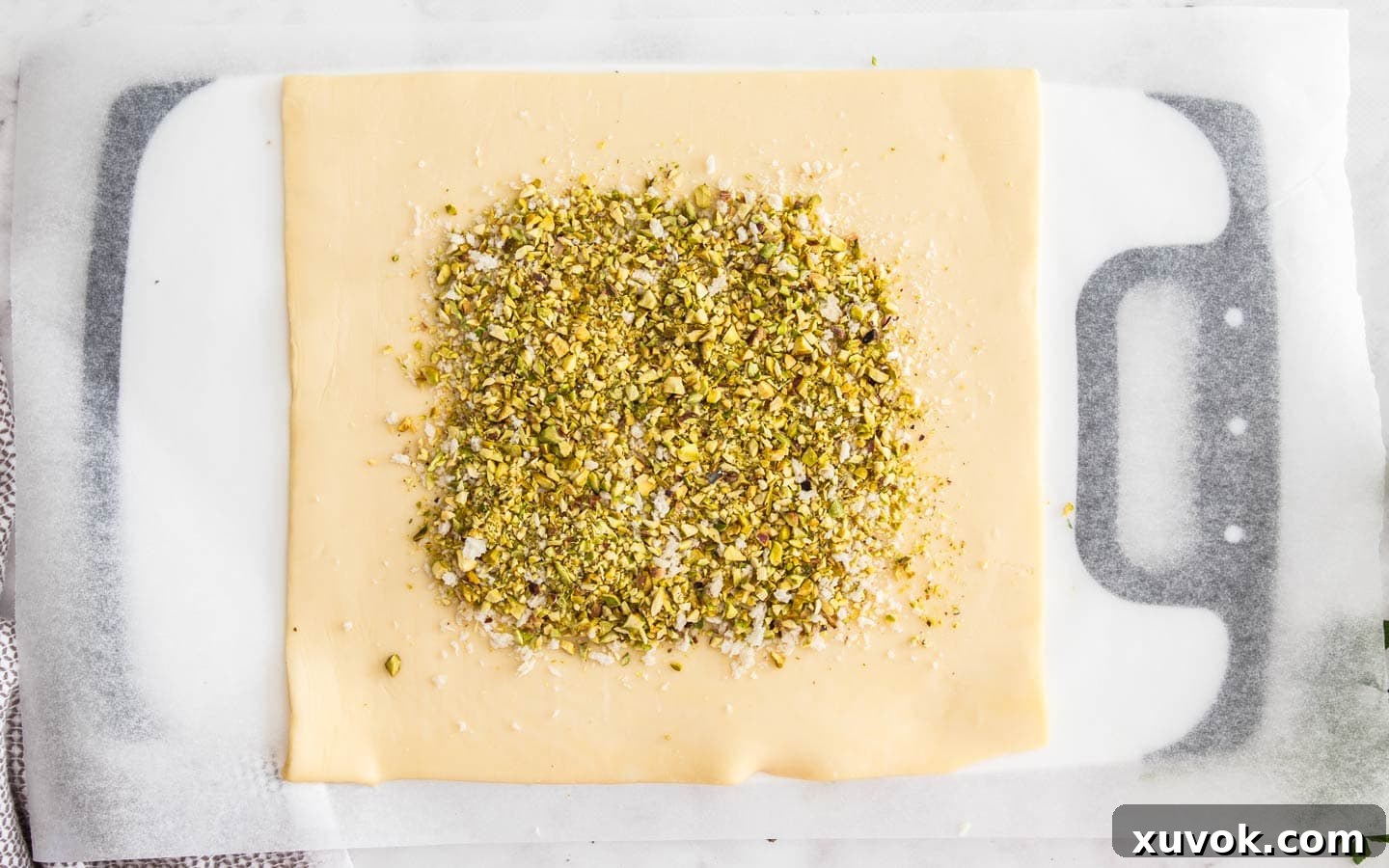 The crumb mixture of breadcrumbs and pistachios spread on the puff pastry.