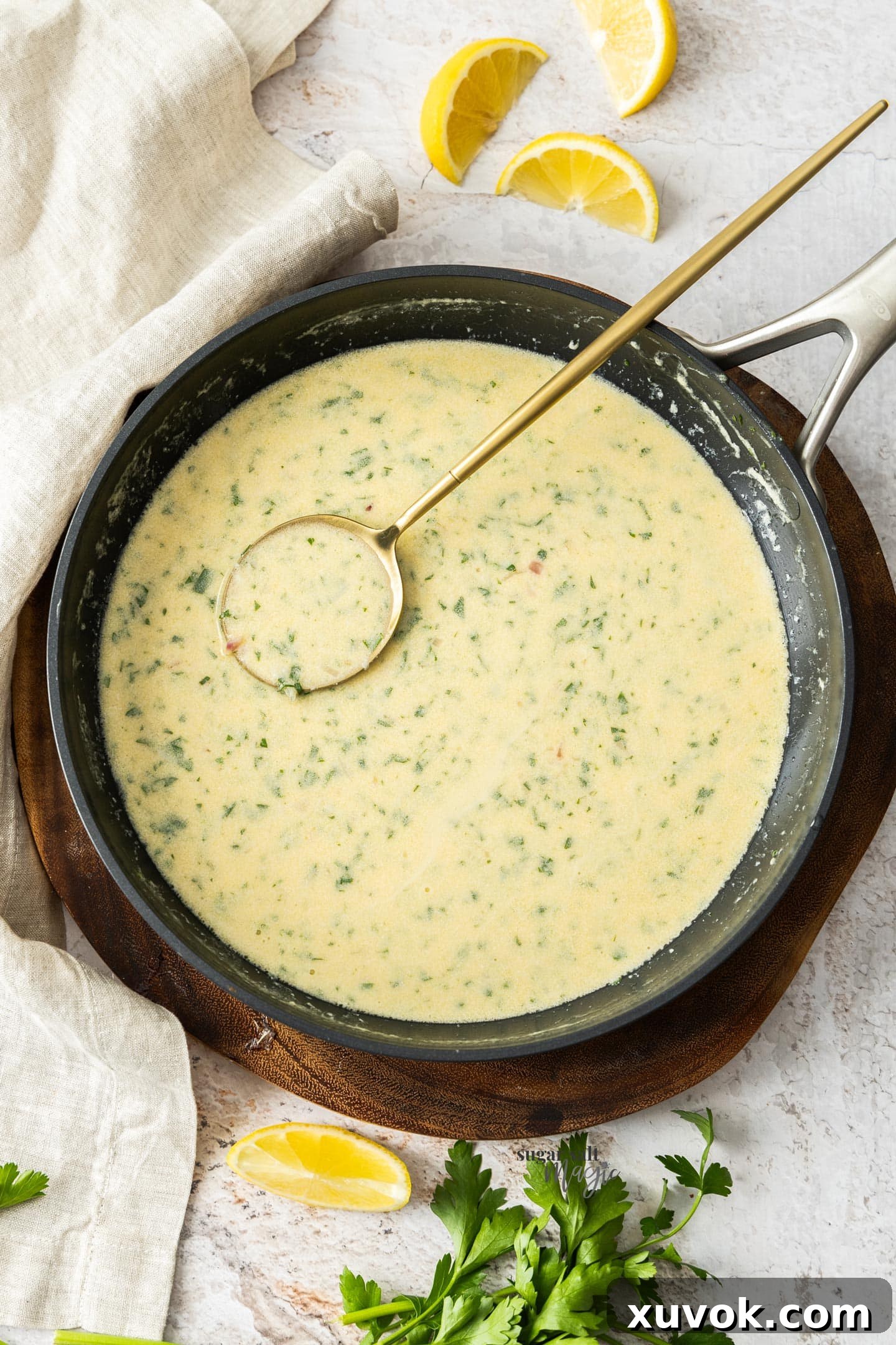 Top down view of the creamy white wine sauce in the pan it was cooked in, highlighting its rich, smooth texture and inviting golden hue.