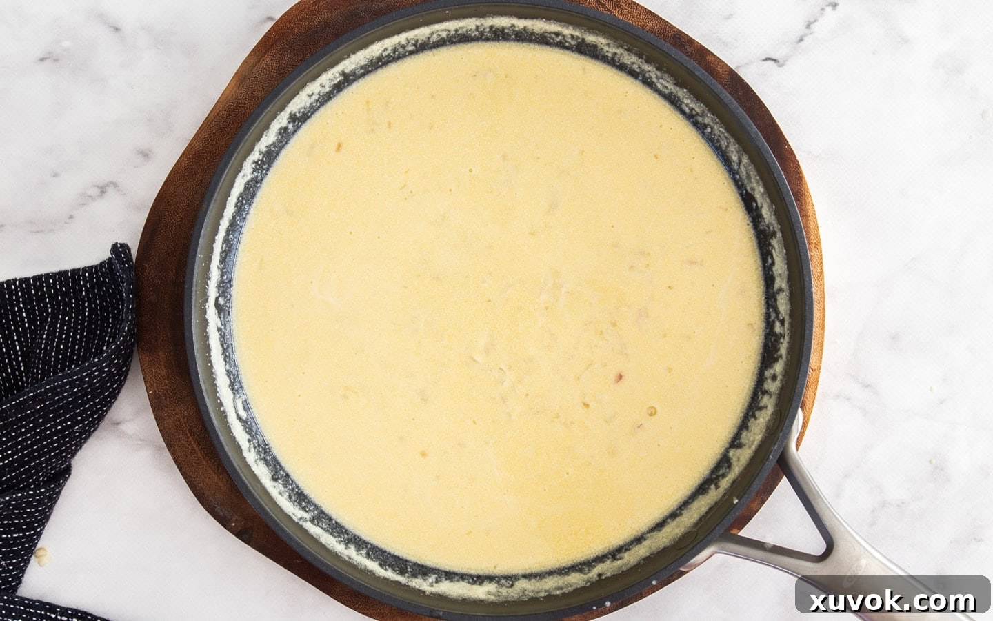 The creamy white wine sauce shimmering in the pan, ready for the final, essential additions of fresh lemon juice and vibrant parsley to complete its flavor profile.