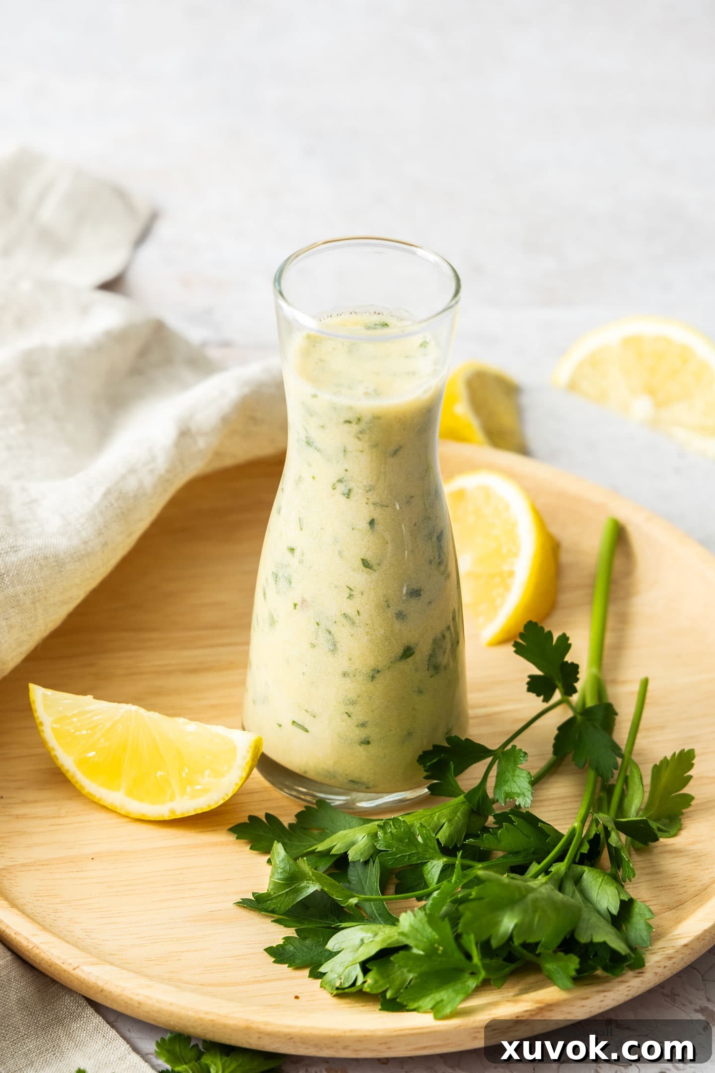 A small elegant carafe beautifully filled with homemade creamy white wine sauce, highlighting its silky smooth texture and inviting color, ready to be served.