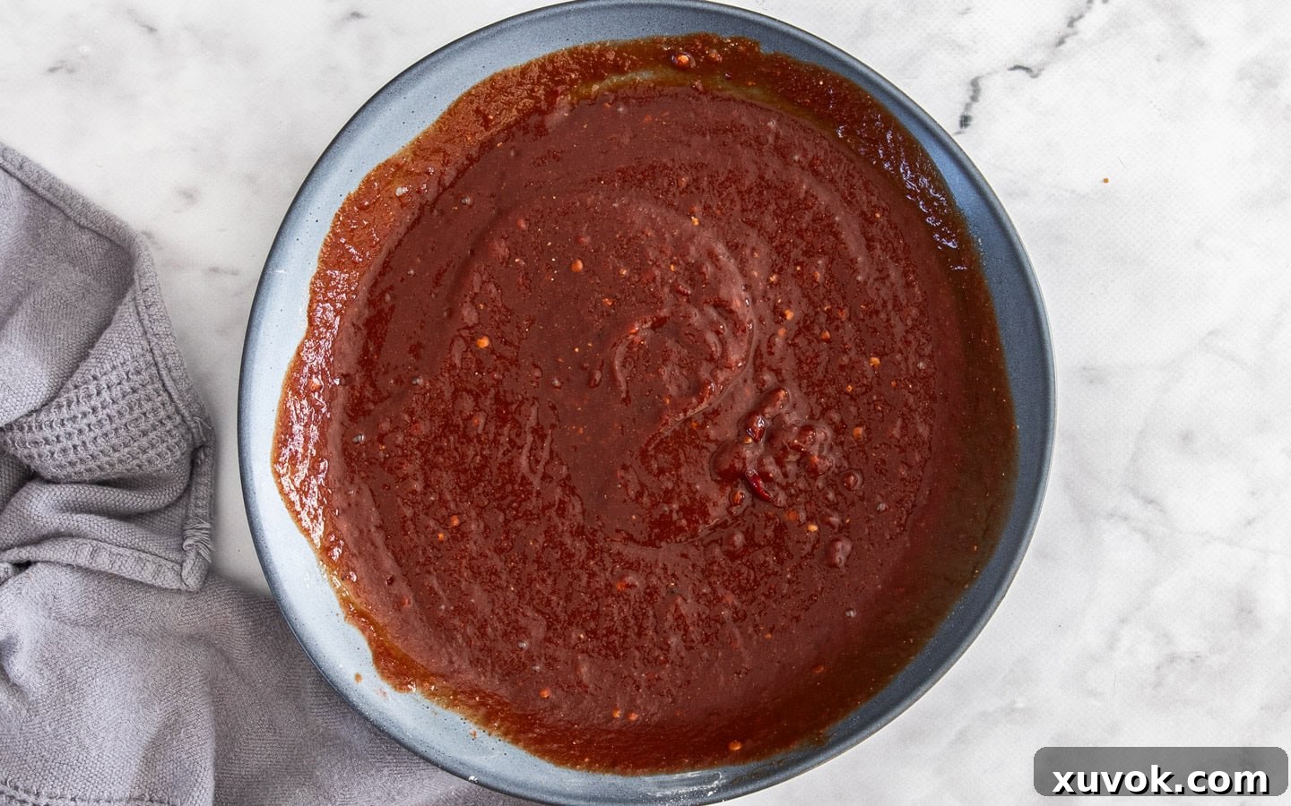 A large bowl filled with the freshly mixed homemade BBQ sauce, ready for the pork ribs.