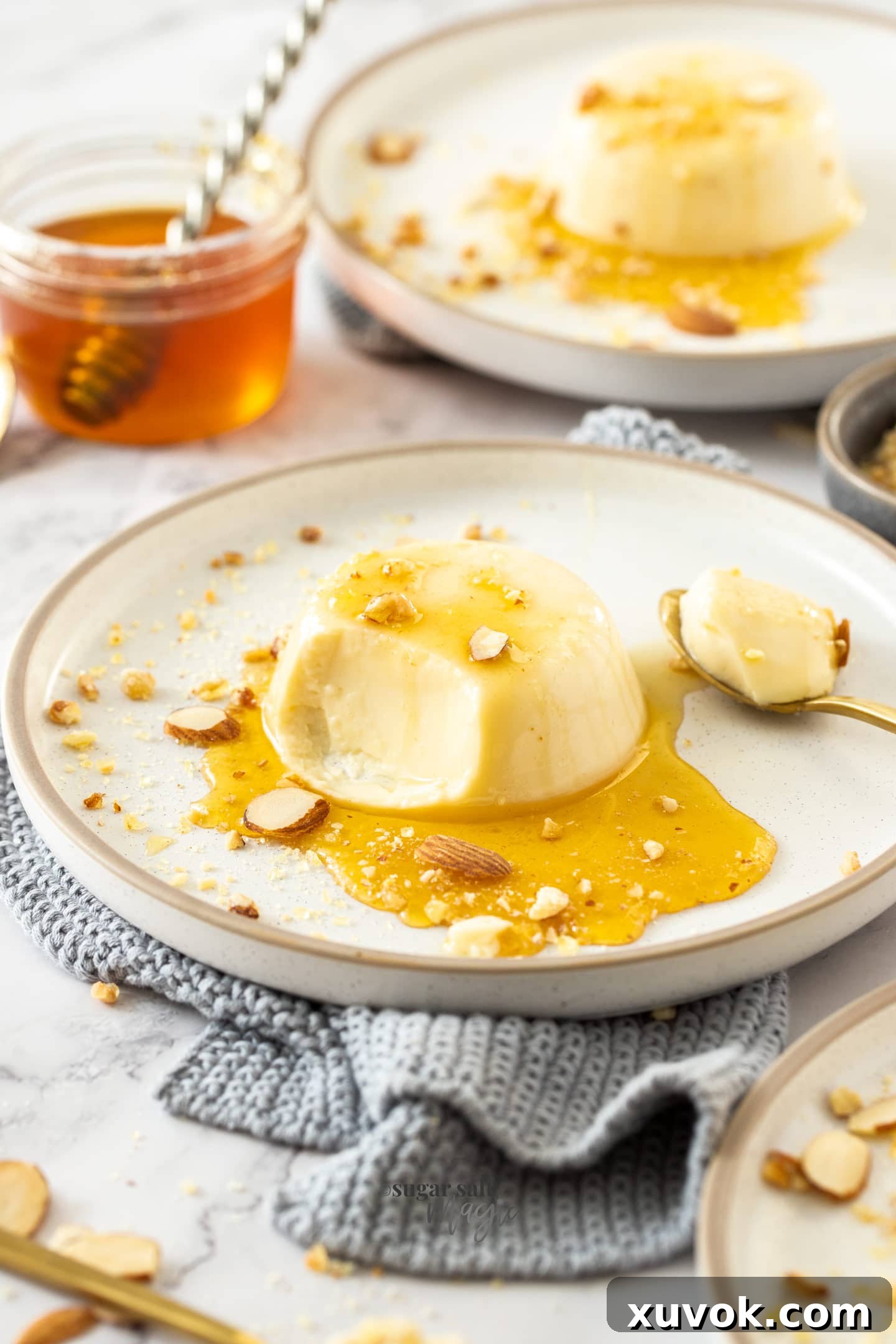 A scoop taken out of a honey panna cotta, showing its smooth, creamy texture.