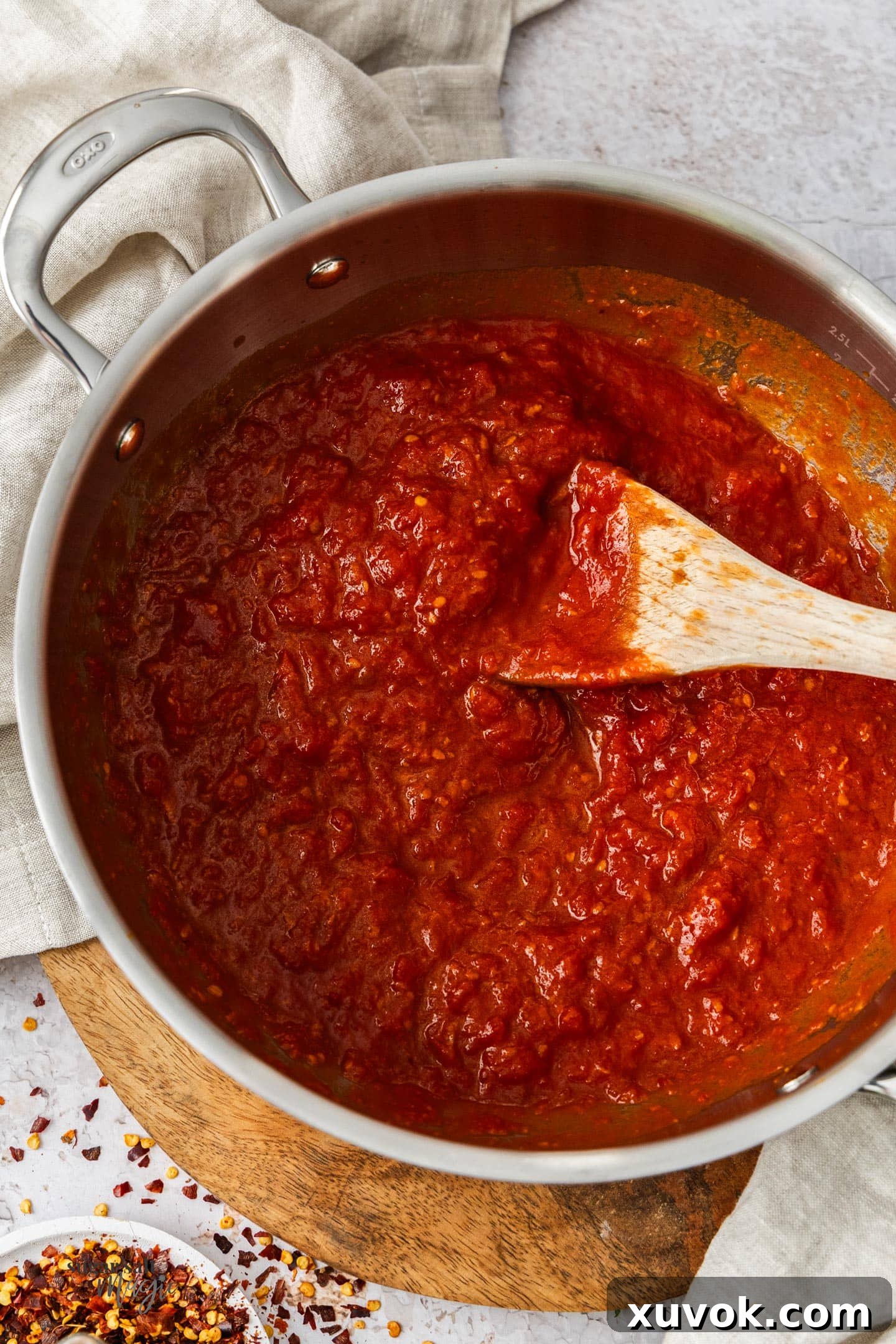 Top down view of a pan filled with arrabbiata sauce, showcasing its vibrant red color and rich texture.