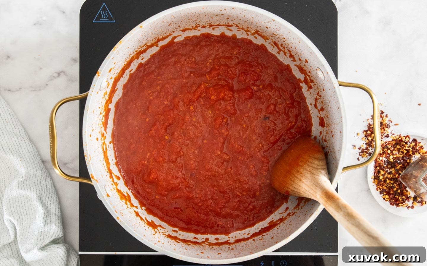 The arrabbiata sauce after it has simmered and reduced, showing a rich, thick texture.