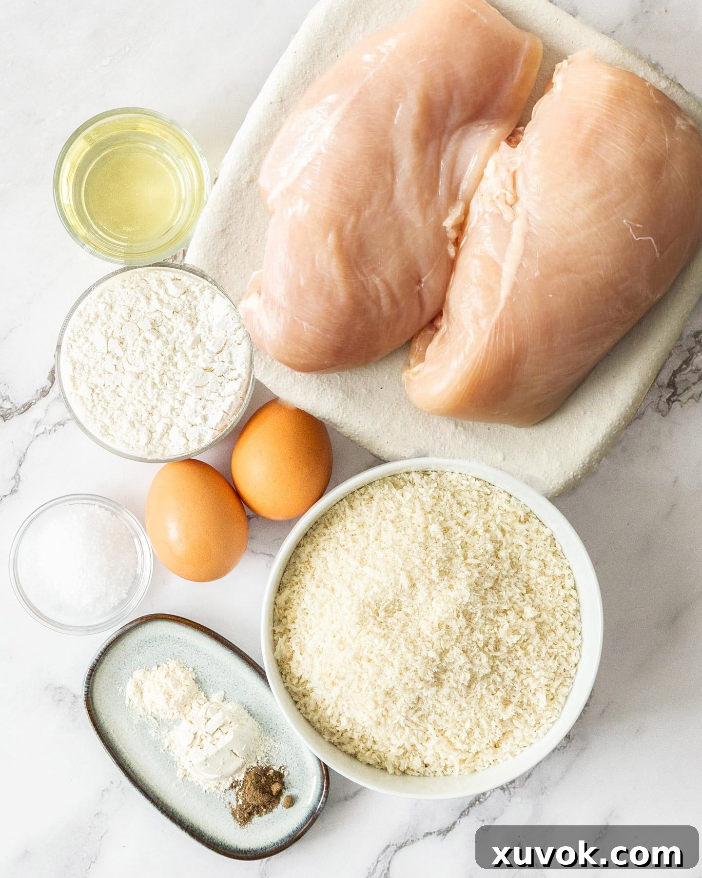 Ingredients for panko chicken, including chicken breasts, panko breadcrumbs, eggs, and spices.
