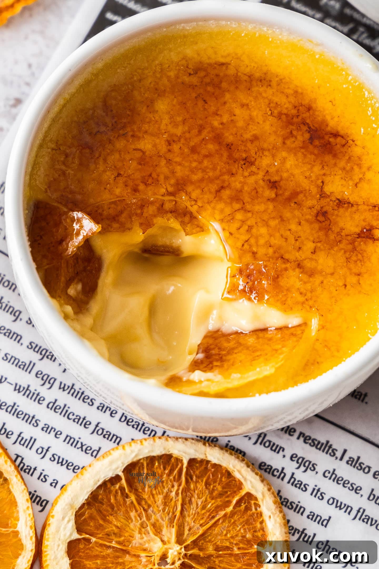 Close-up of the perfectly creamy interior of an orange creme brulee, highlighting its smooth texture and light orange hue.