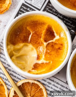 Top down view of a crème brûlée with a perfectly cracked toffee top, ready to be enjoyed.