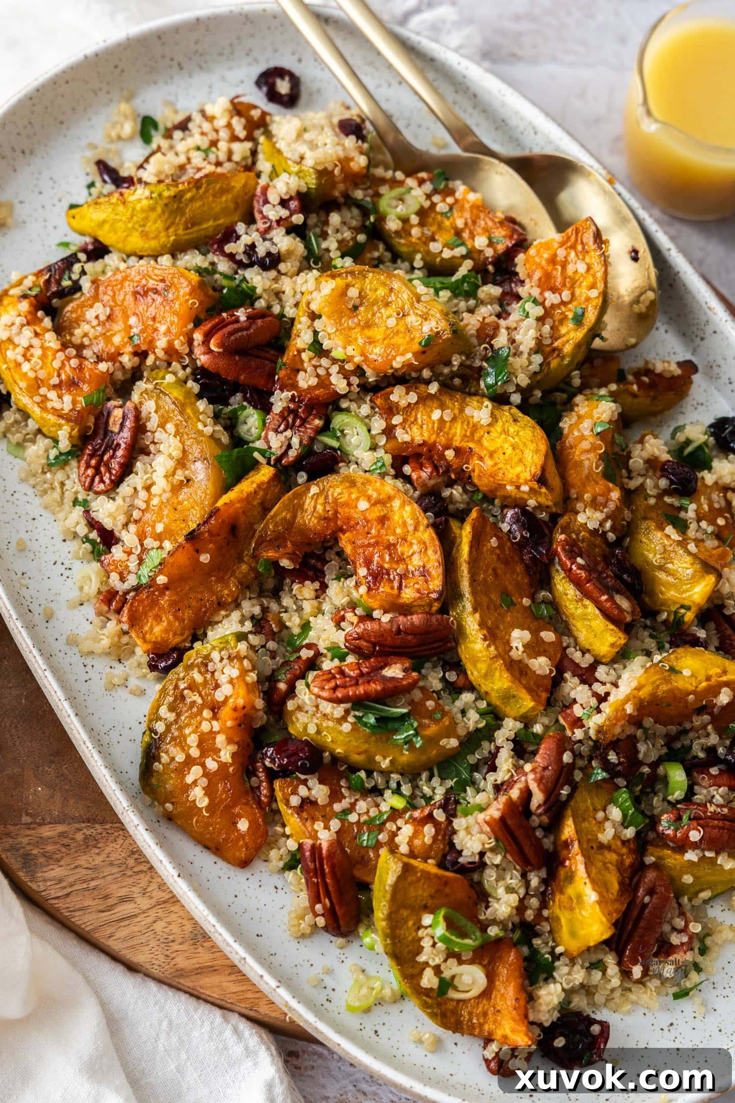 The finished pumpkin quinoa salad beautifully arranged on an oblong serving platter, ready to be enjoyed as a centerpiece dish.
