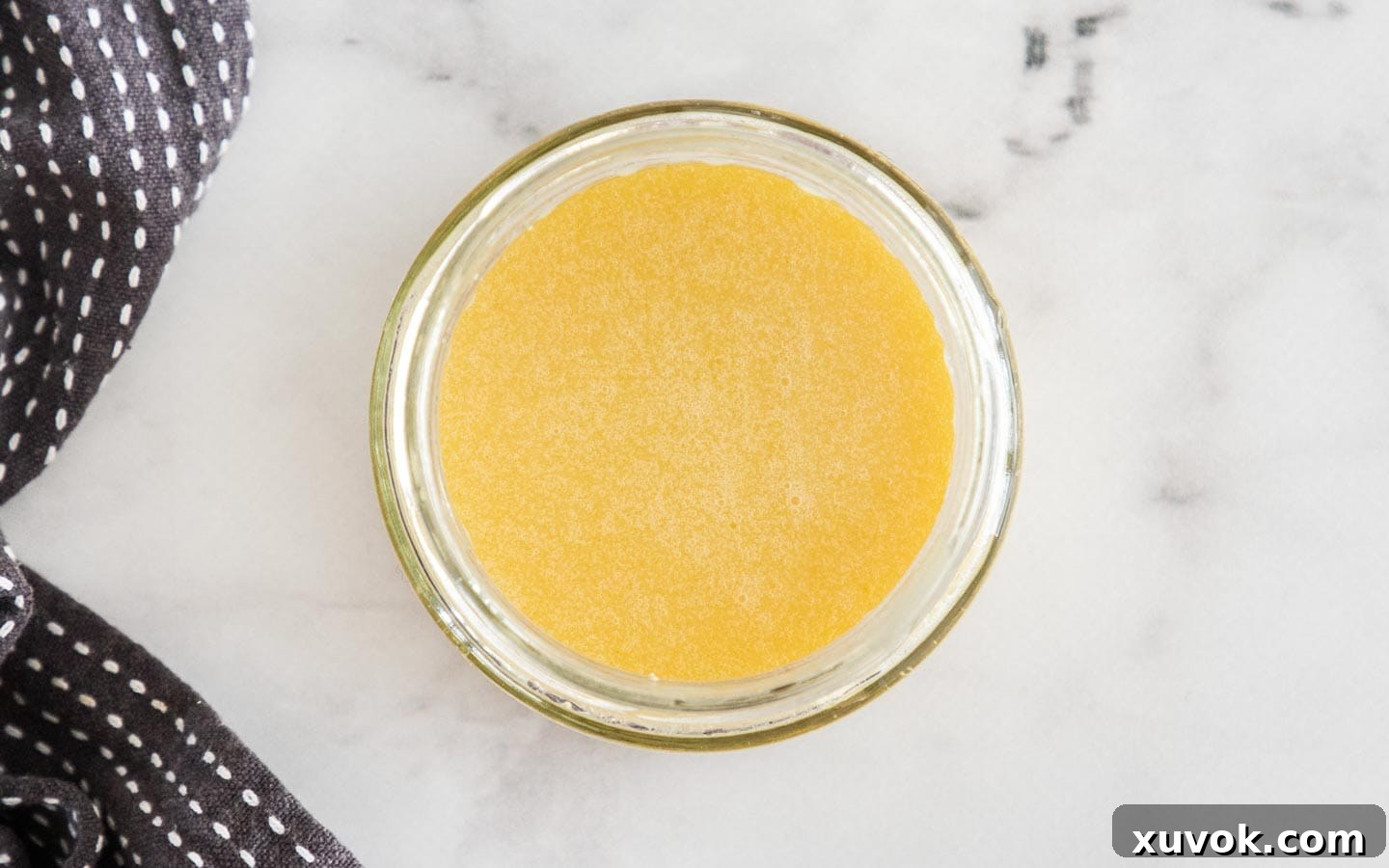 A small bowl of bright orange dressing, ready to be drizzled over the pumpkin quinoa salad.