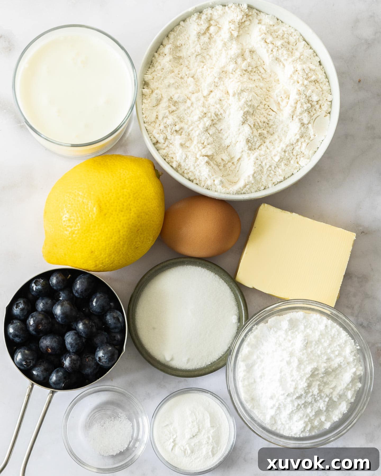 Ingredients for blueberry and lemon scones laid out on a table.