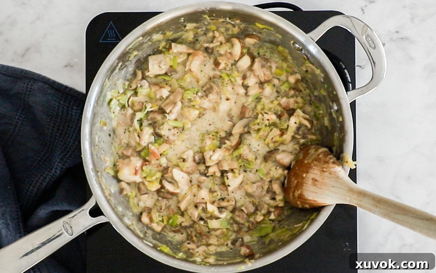 The finished creamy chicken and vegetable filling in a pan, after the sour cream has been stirred in, ready to be chilled.