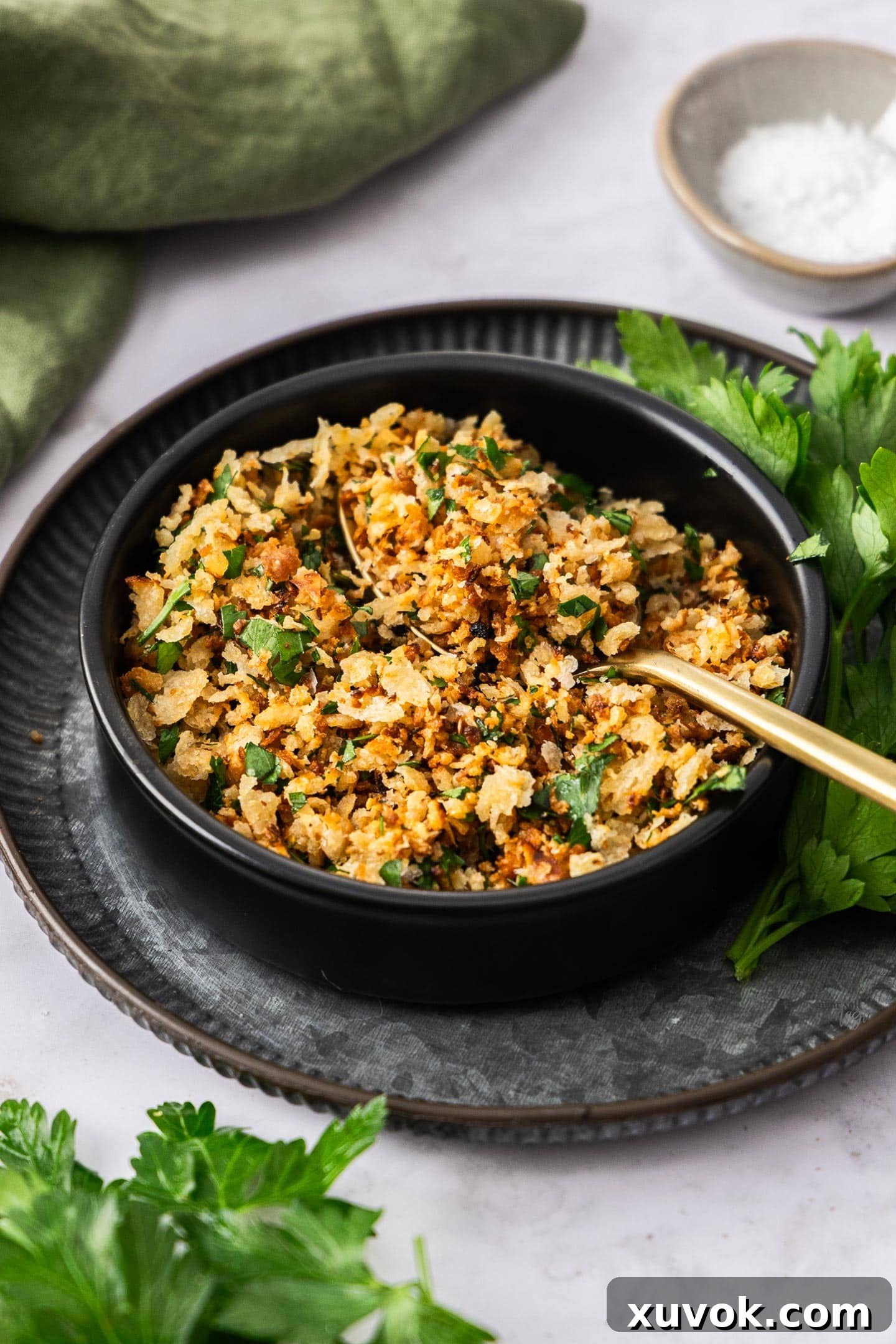 A black bowl filled with golden, crispy pangrattato, showcasing its inviting texture and rich color, ready to be sprinkled over any dish.