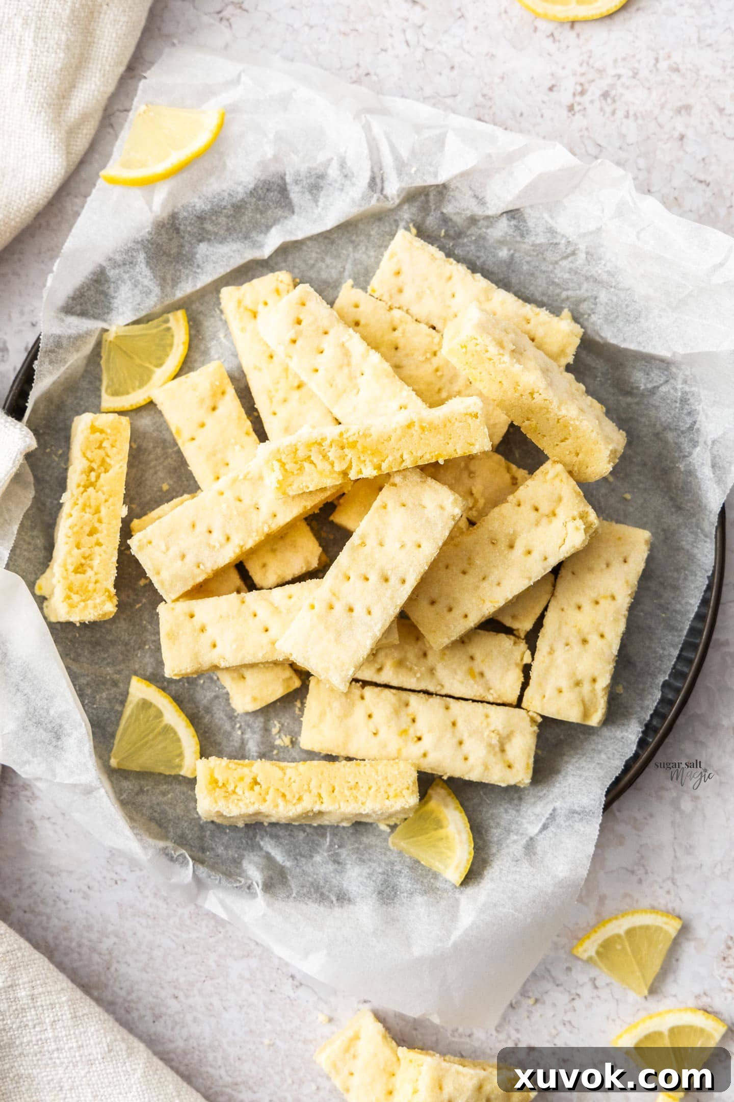 Top down view of a pile of lemon shortbread on a tray.