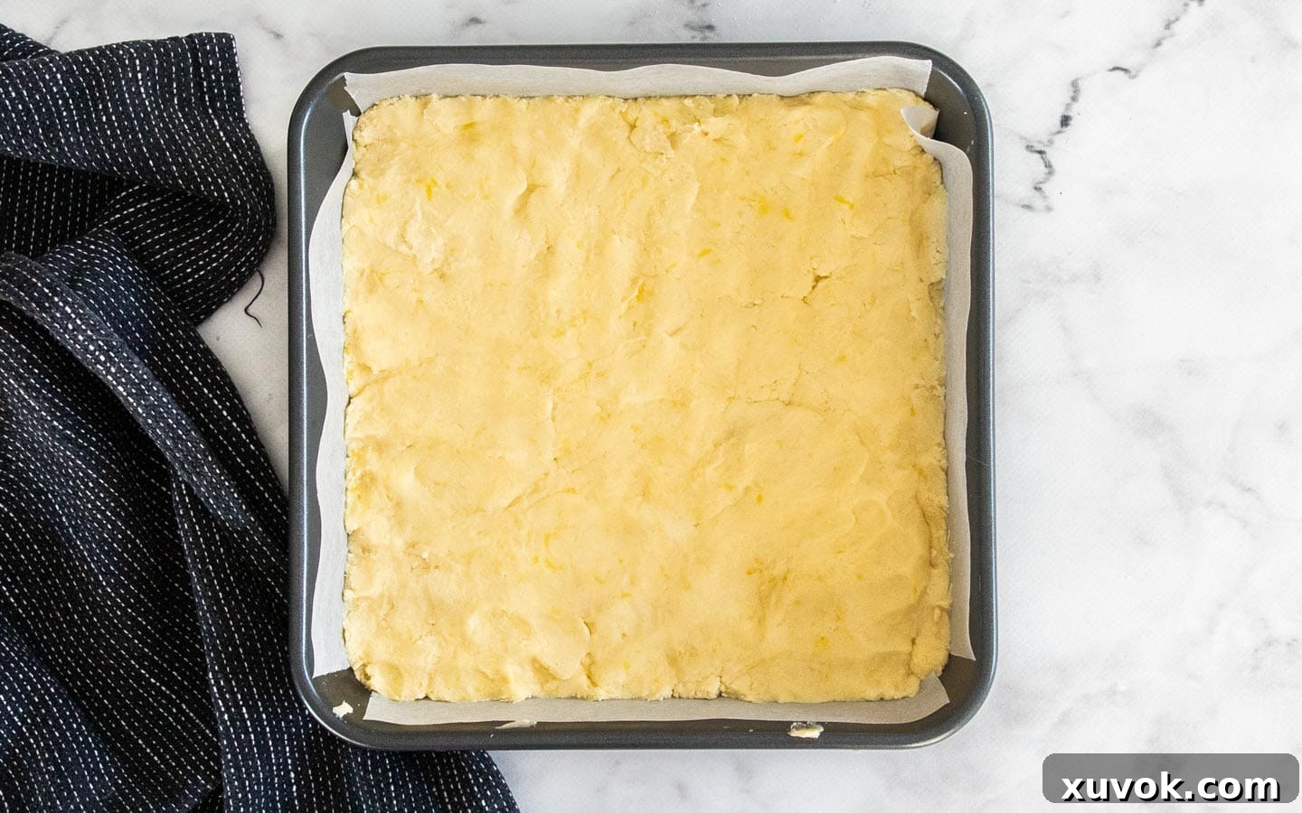The dough pressed into a baking pan.
