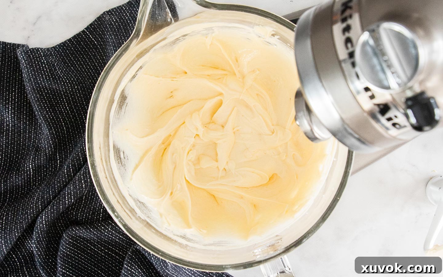 Cake batter after eggs and vanilla have been beaten in, showing a slightly fluffed texture.