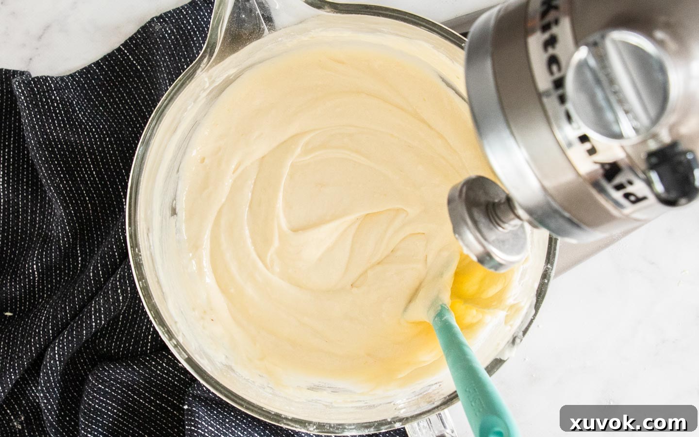 Fully prepared cake batter in a mixing bowl, smooth and ready for cake pans.
