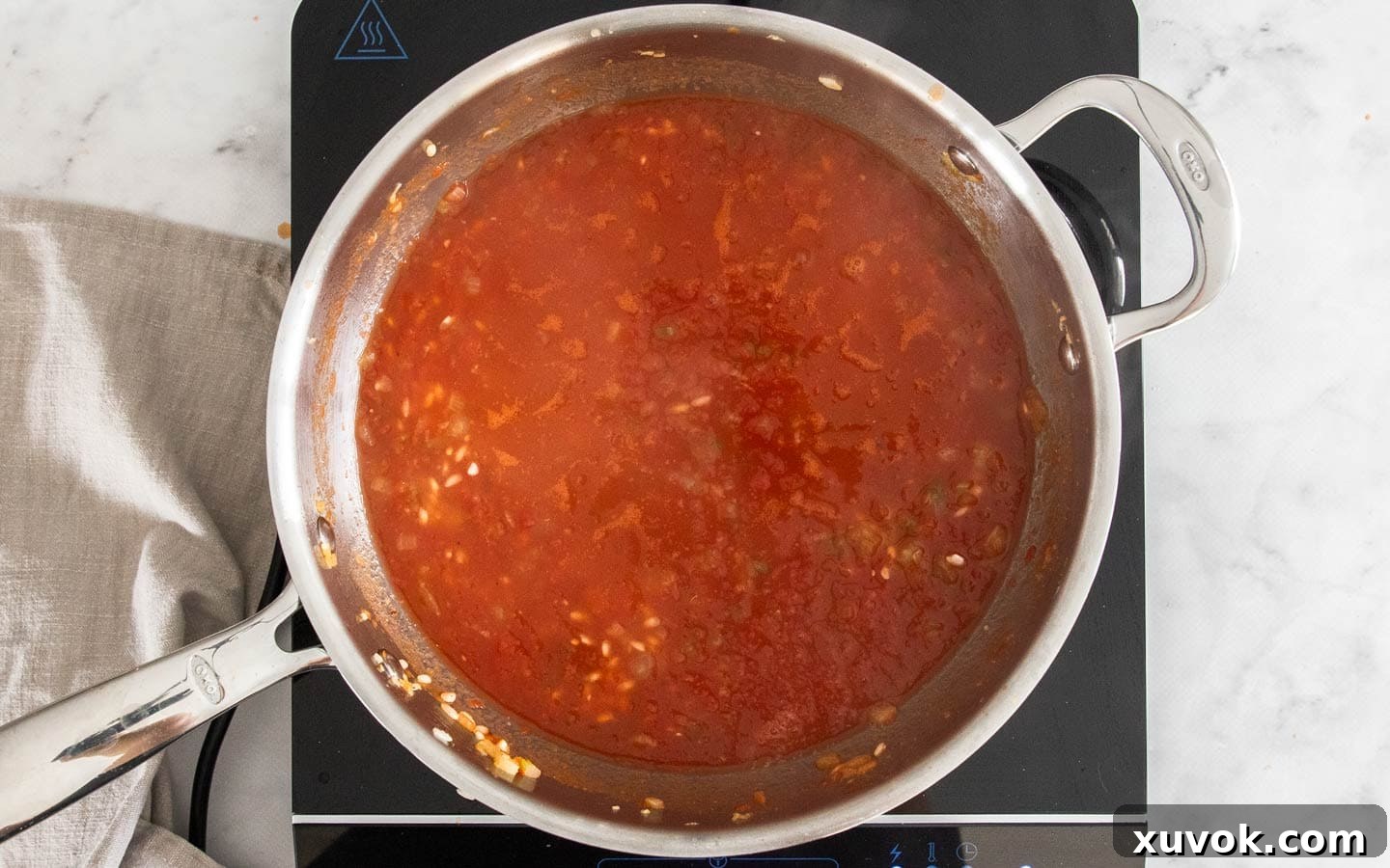 All the remaining tomato stock added to the pan, with a lid on, ready to simmer.
