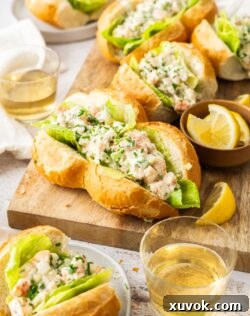 A large, tempting prawn roll served on a wooden board, showcasing its rich filling.