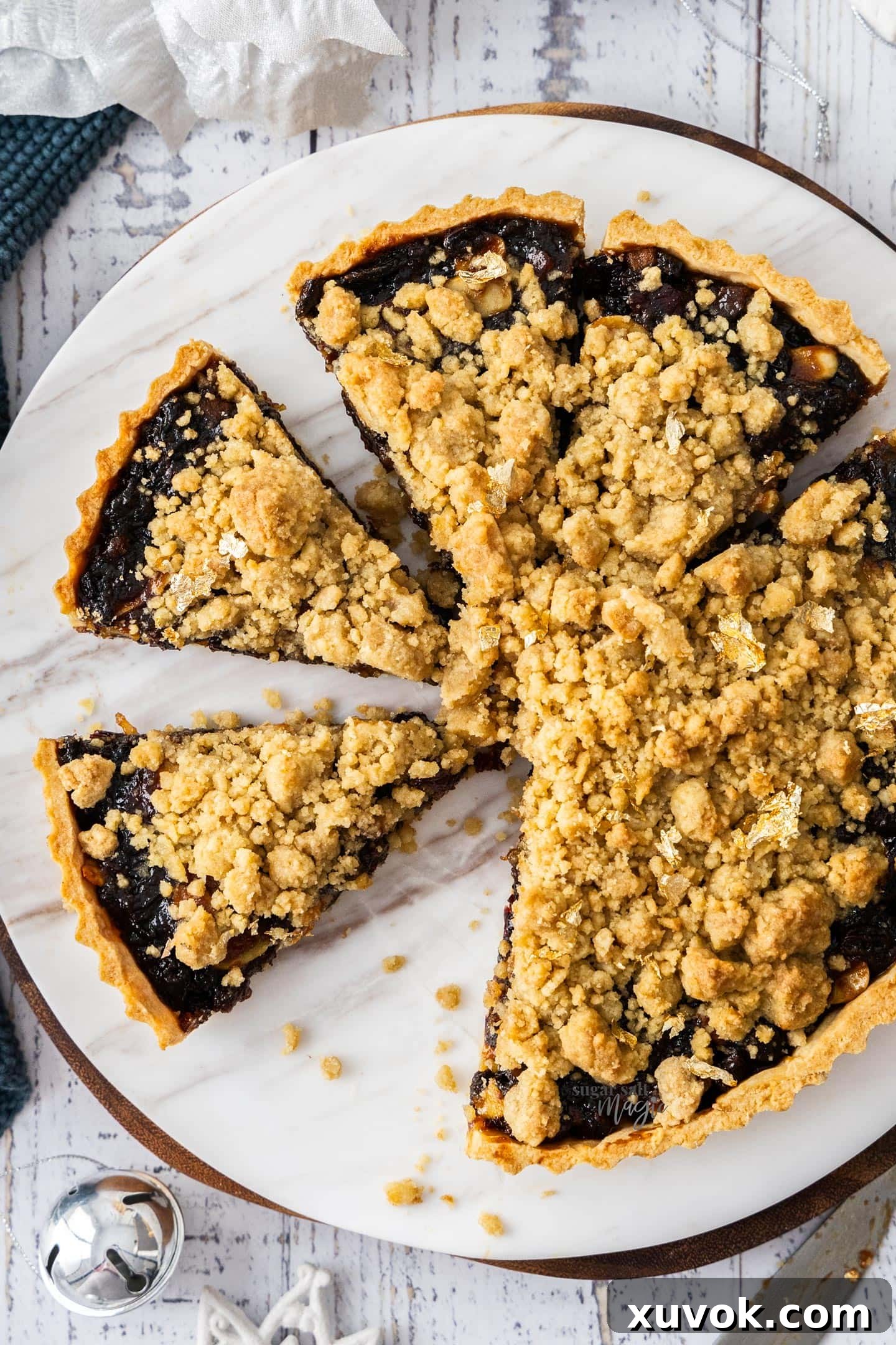 Top down view of fruit mince tart on a marble platter.