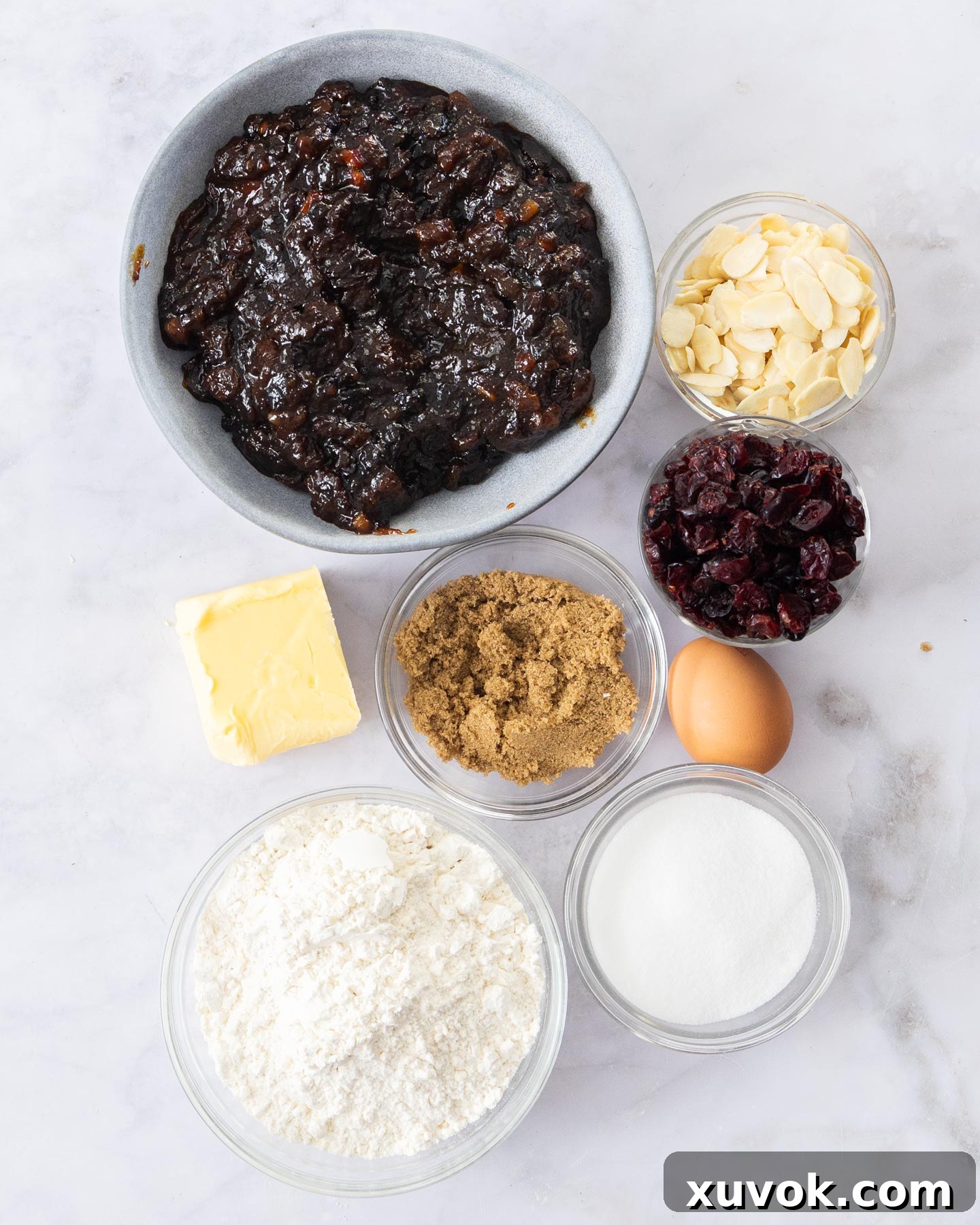 Ingredients for mince pie tart on a marble surface.
