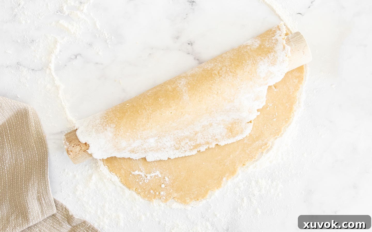 The pastry wrapped over a rolling pin.