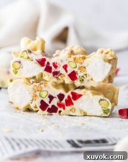 Two slices of white chocolate rocky road stacked one on top of the other.