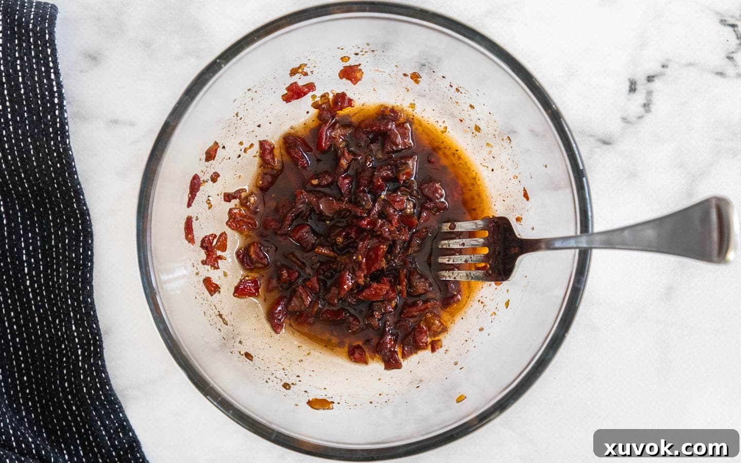 The sun dried tomato dressing in a glass bowl.