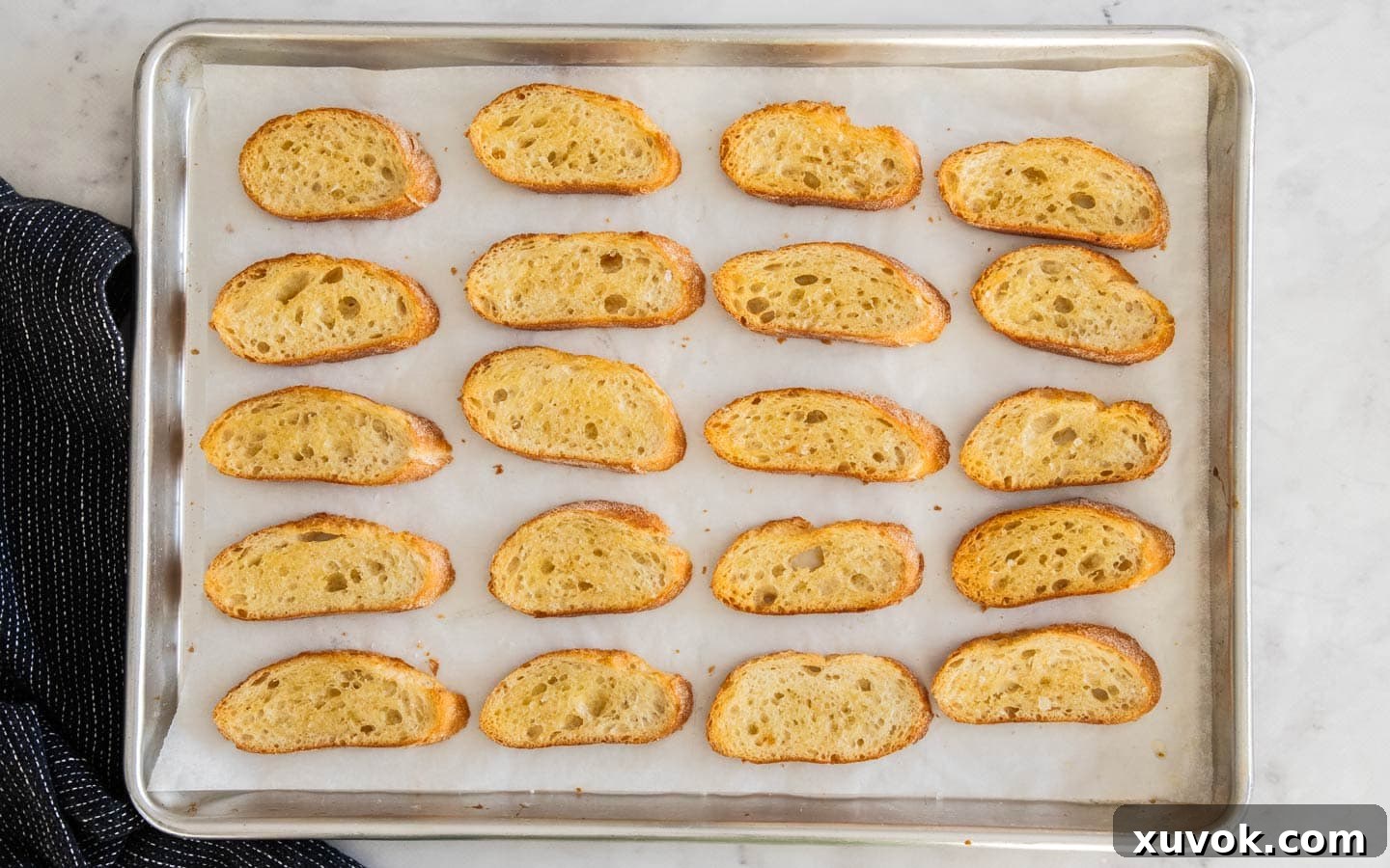 Baked crostini on a baking sheet.