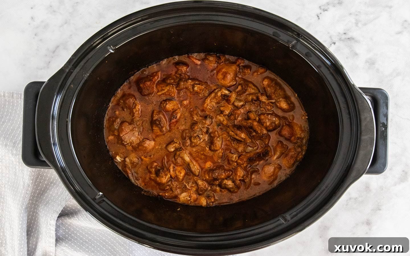 The stroganoff in the slow cooker after 5 hours of cooking, before adding final ingredients.