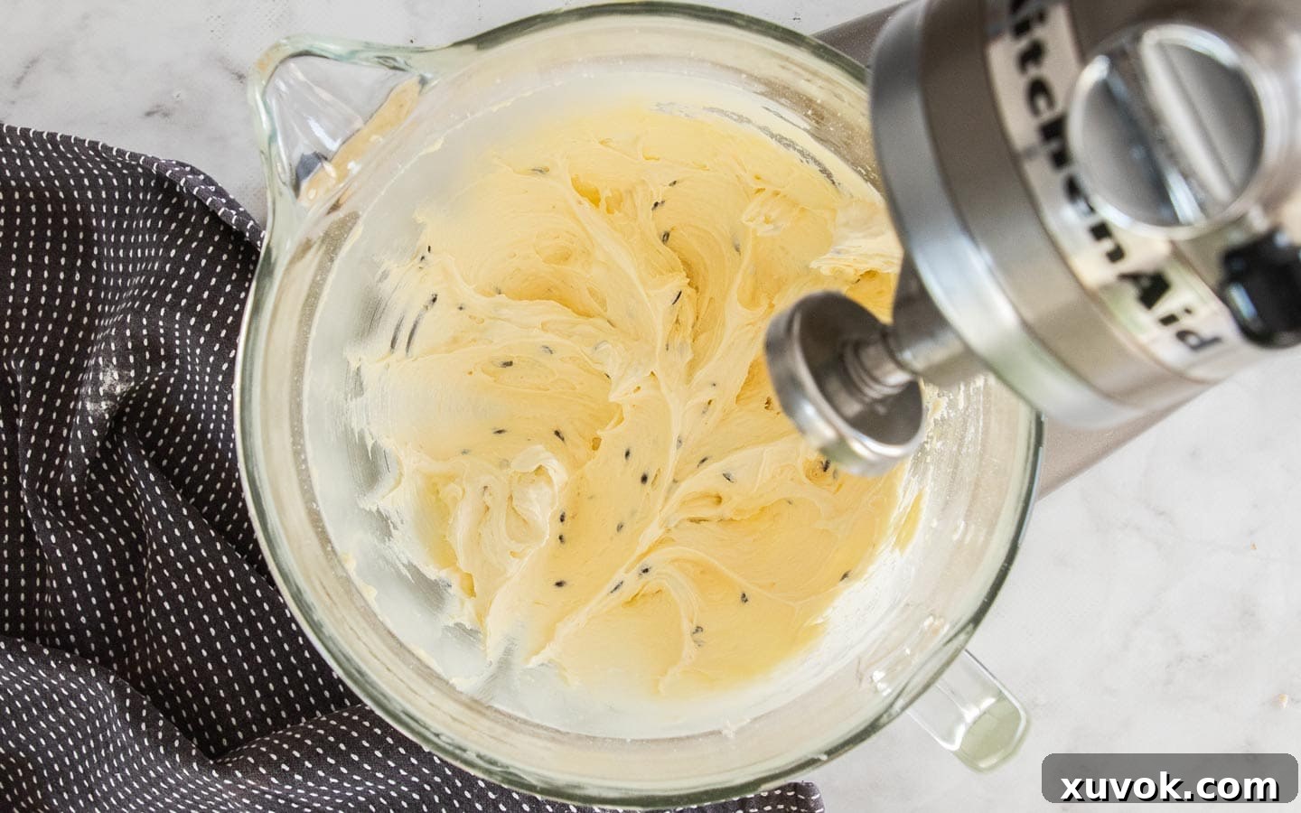 The finished passionfruit buttercream, showing its smooth texture and flecks of seeds, ready to fill the cookies.