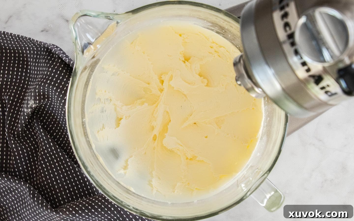 Butter and icing sugar creamed together in the bowl of a stand mixer, creating a smooth, light buttercream base.