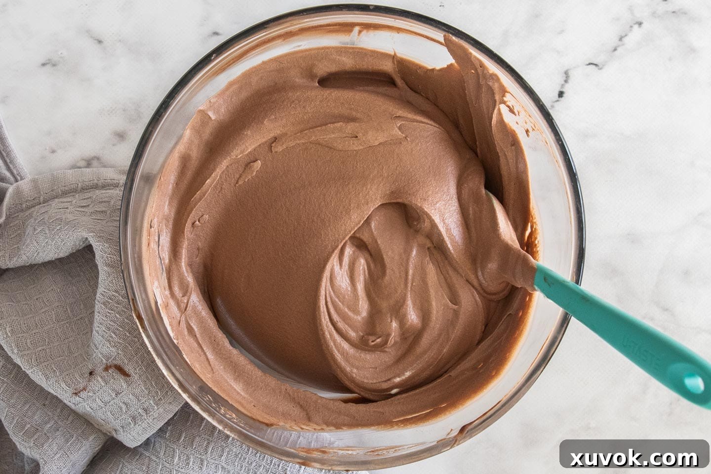The whipped cream and chocolate mixture folded together in a bowl.