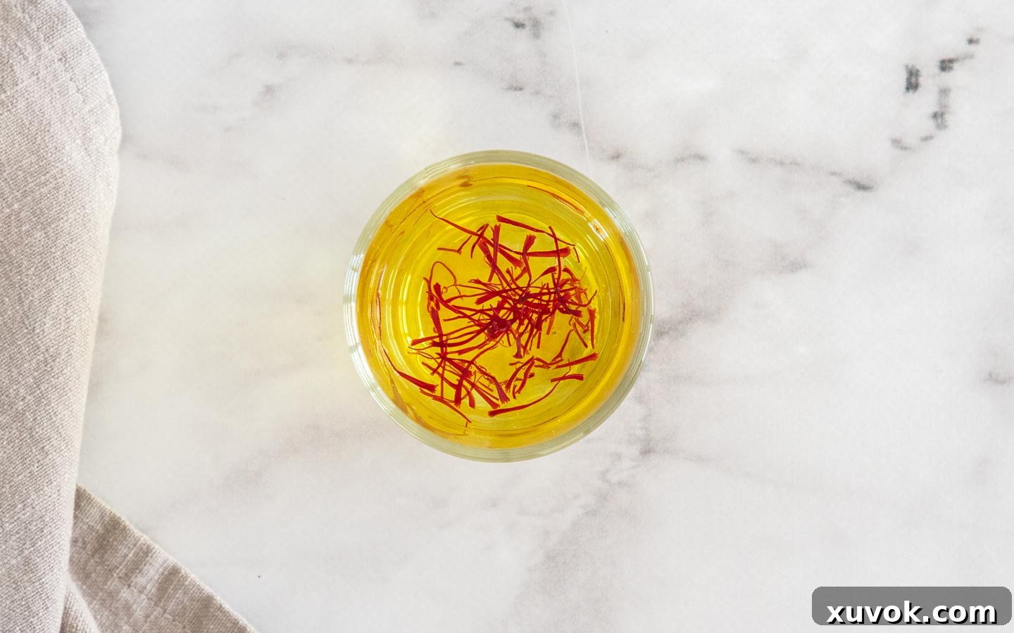 Saffron in water in a small glass.