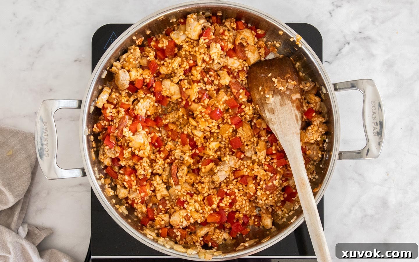 Rice and tomato paste added to the pan.