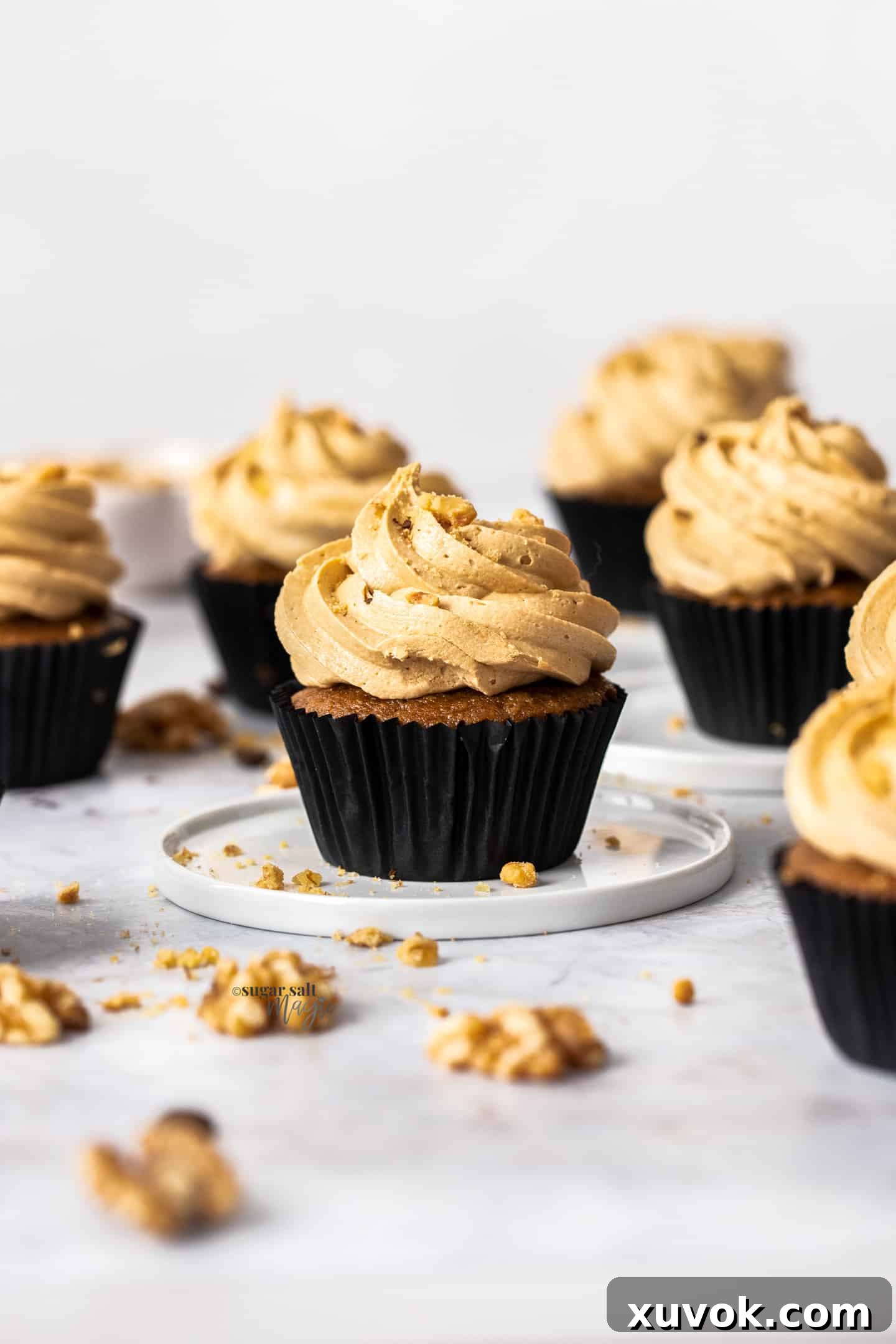 Closeup of a coffee cupcake on a small plate.