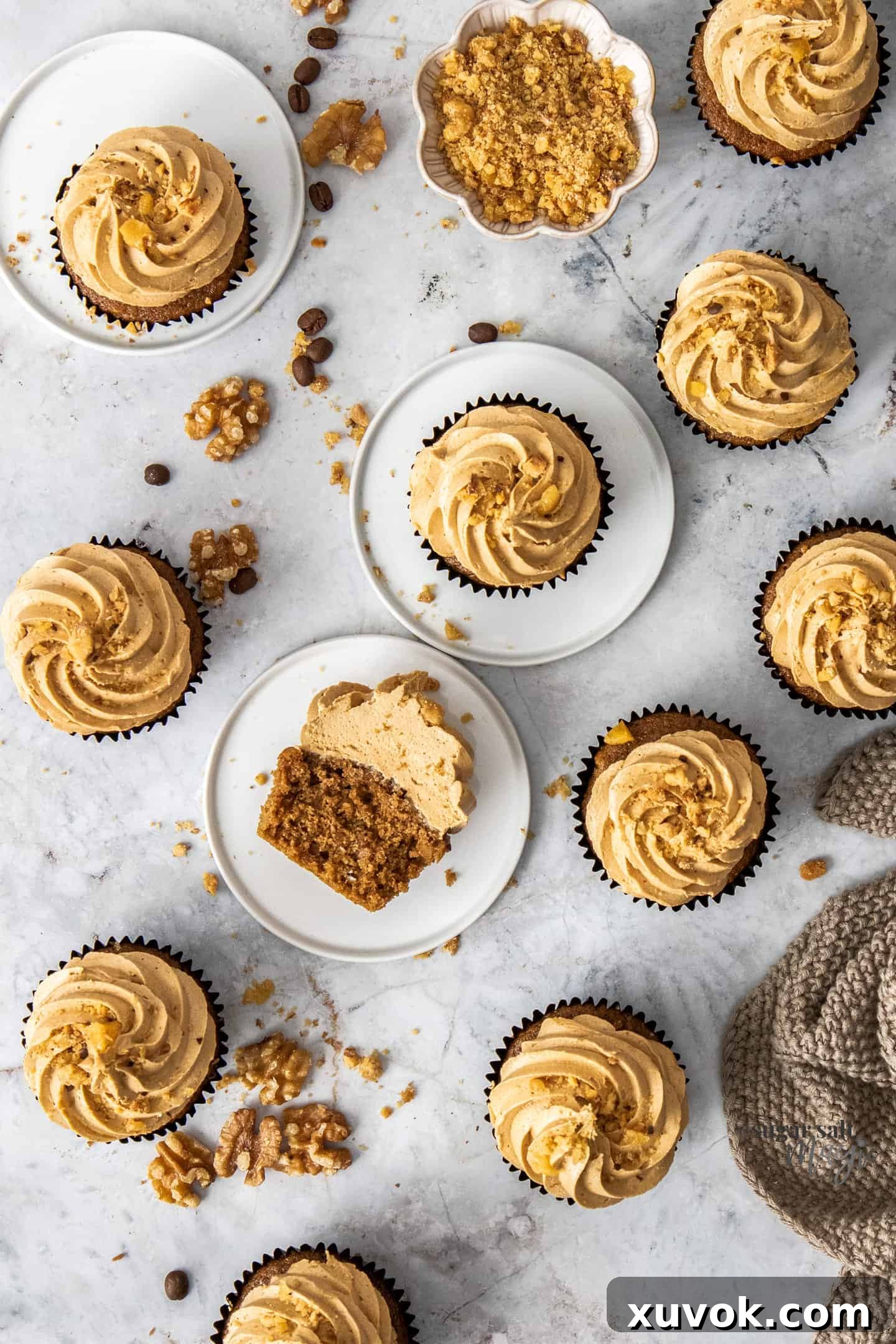 Top down view of a batch of coffee and walnut cupcakes.