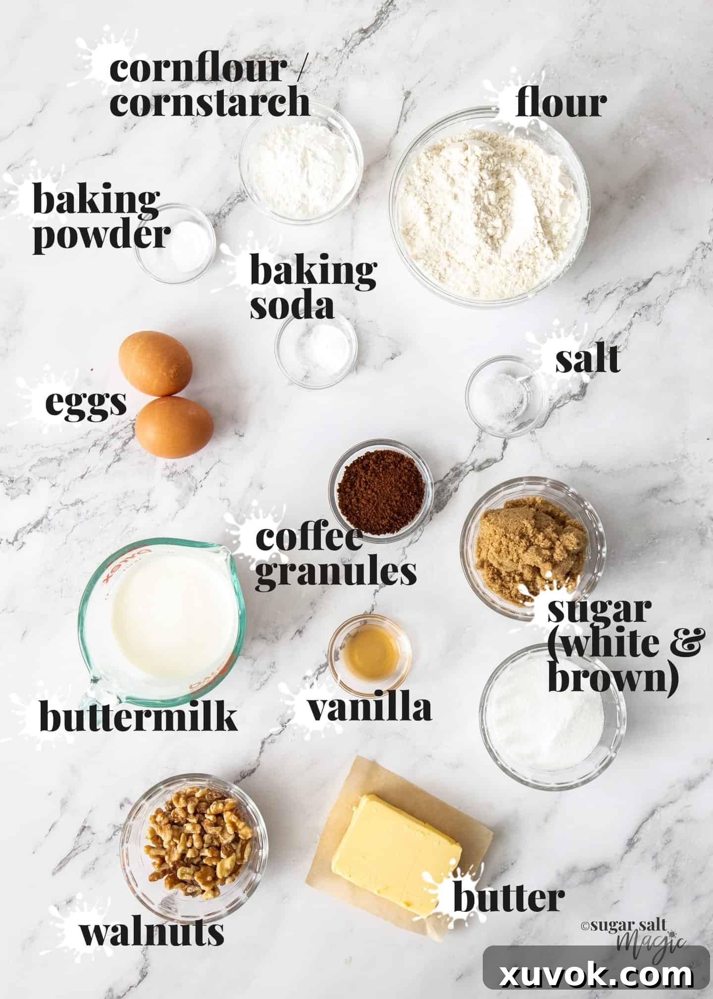 Ingredients for coffee cupcakes on a white marble benchtop.
