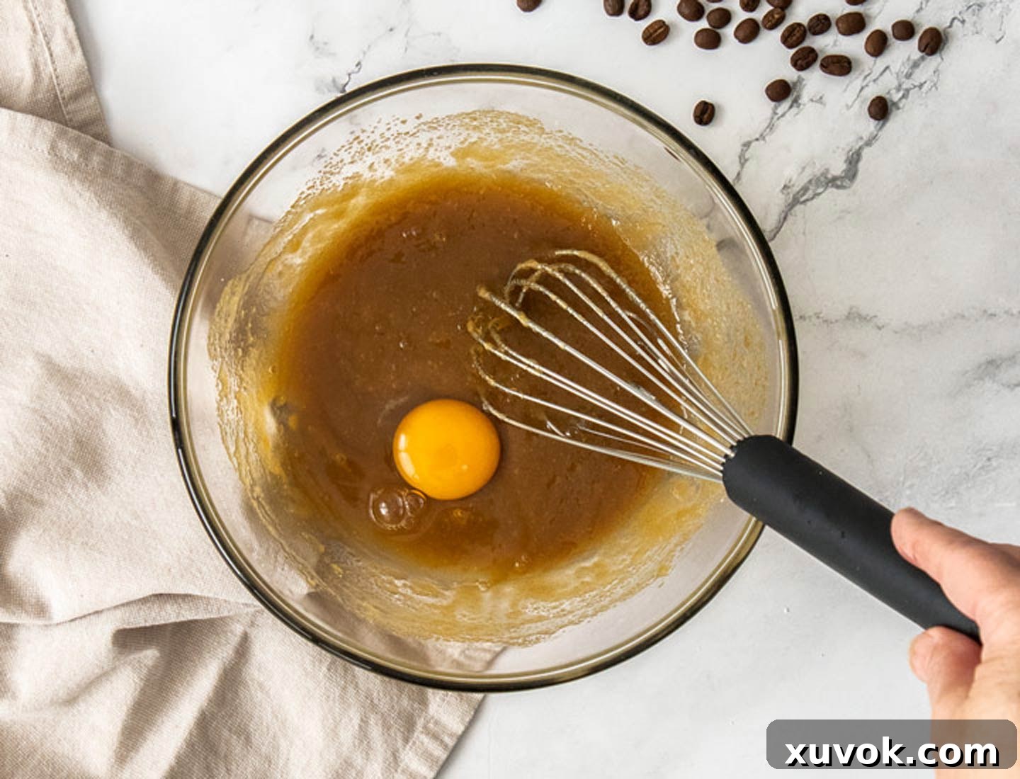 An egg being added to the batter.
