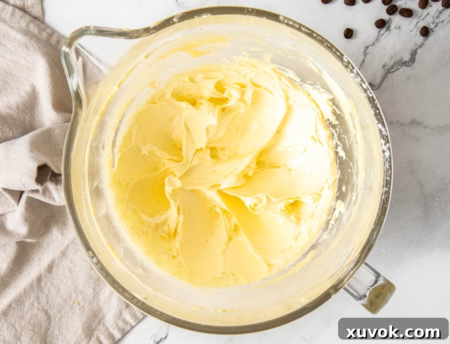 Butter and sugar creamed together in a mixing bowl.