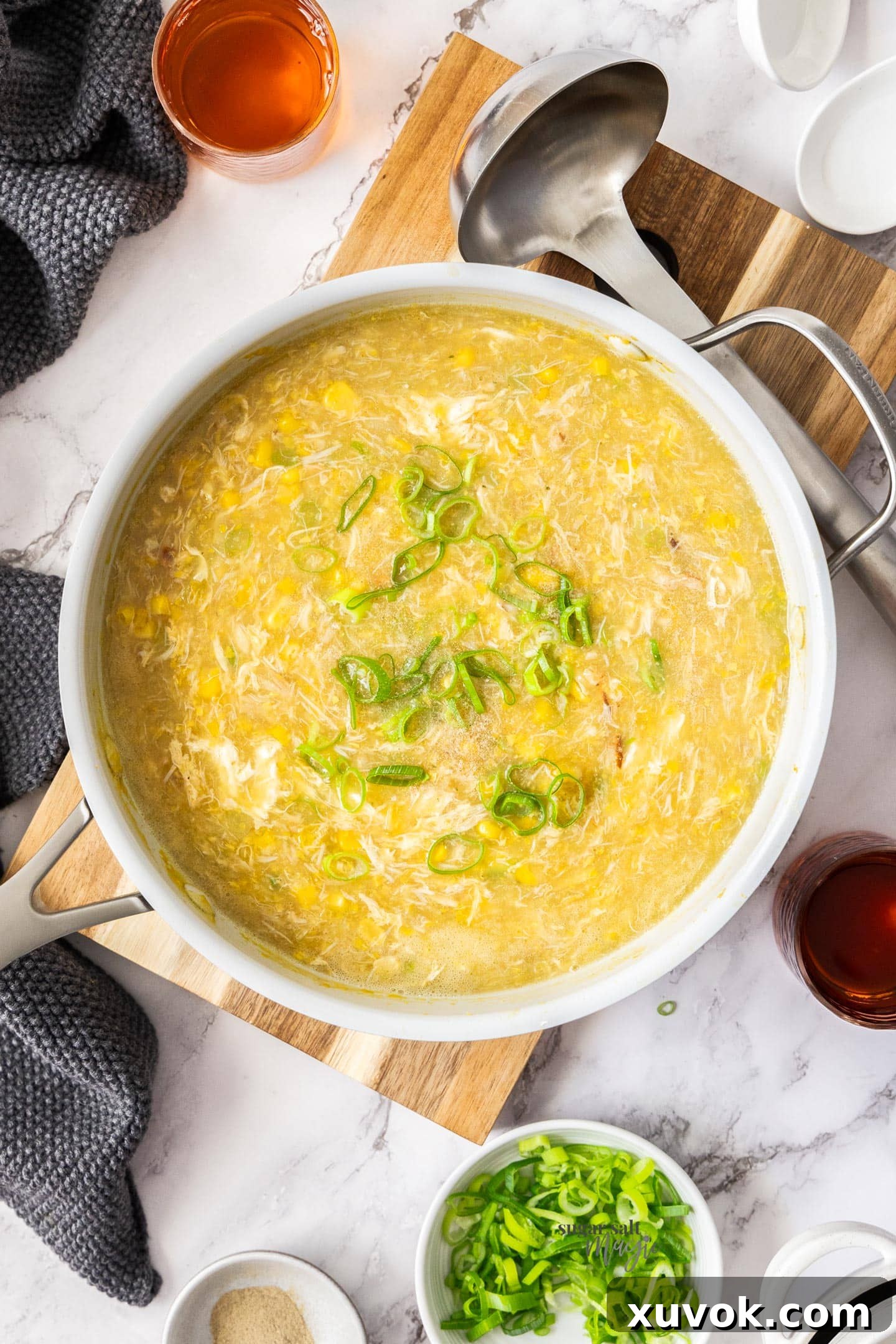 Top down view of the crab and sweetcorn soup in the saucepan.