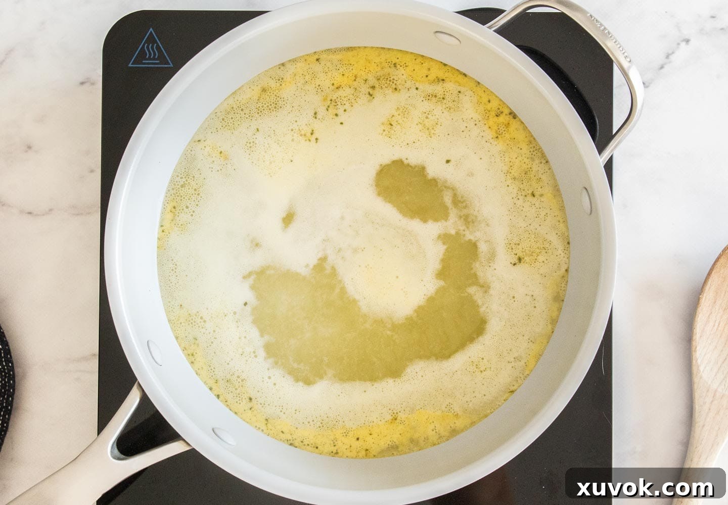The stock boiling in a saucepan.
