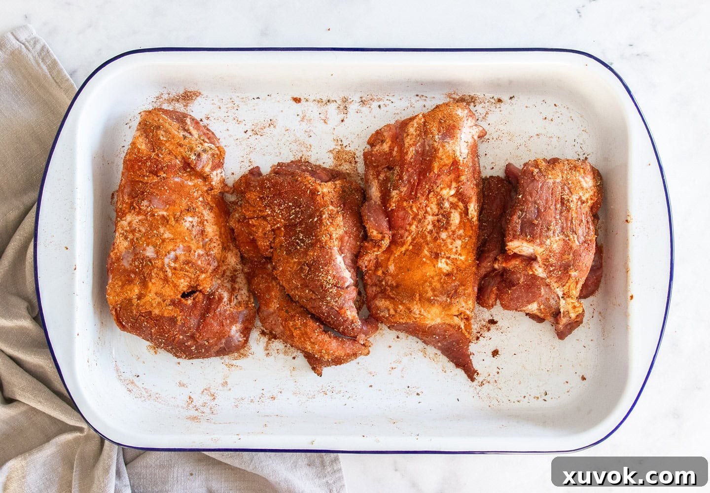 Pork in a pan coated in spice rub.