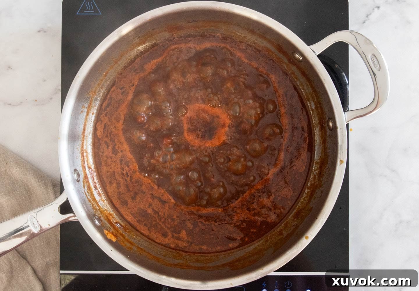 The sauce boiling in a pan.
