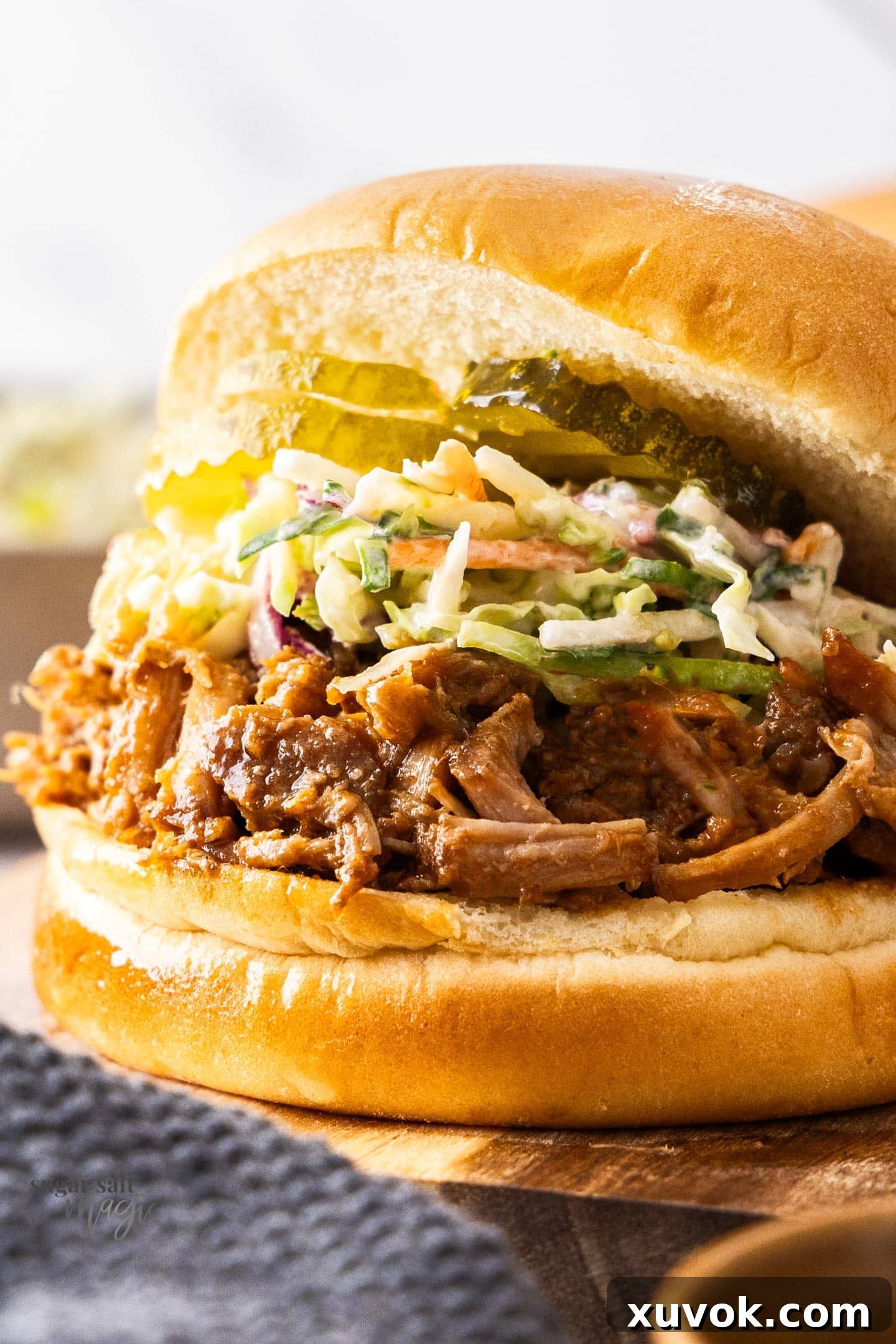 Extreme closeup of a pulled pork burger.