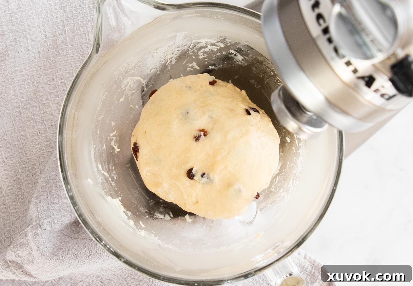 Raw finger bun dough resting in a mixing bowl, prior to its first rise.